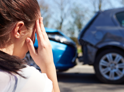 Stressed woman in car accident